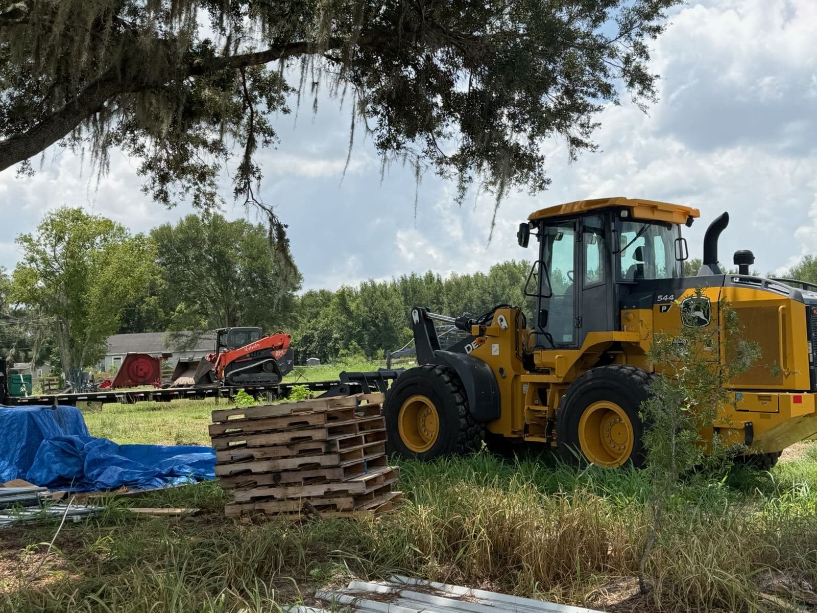 The wheel loader alongside a compact track loader on a work site