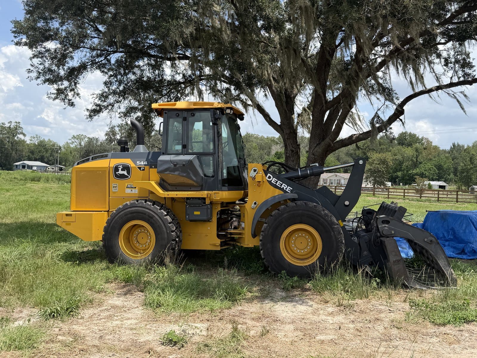 A-1 Land Management's John Deere 544 wheel loader with a grapple attachment