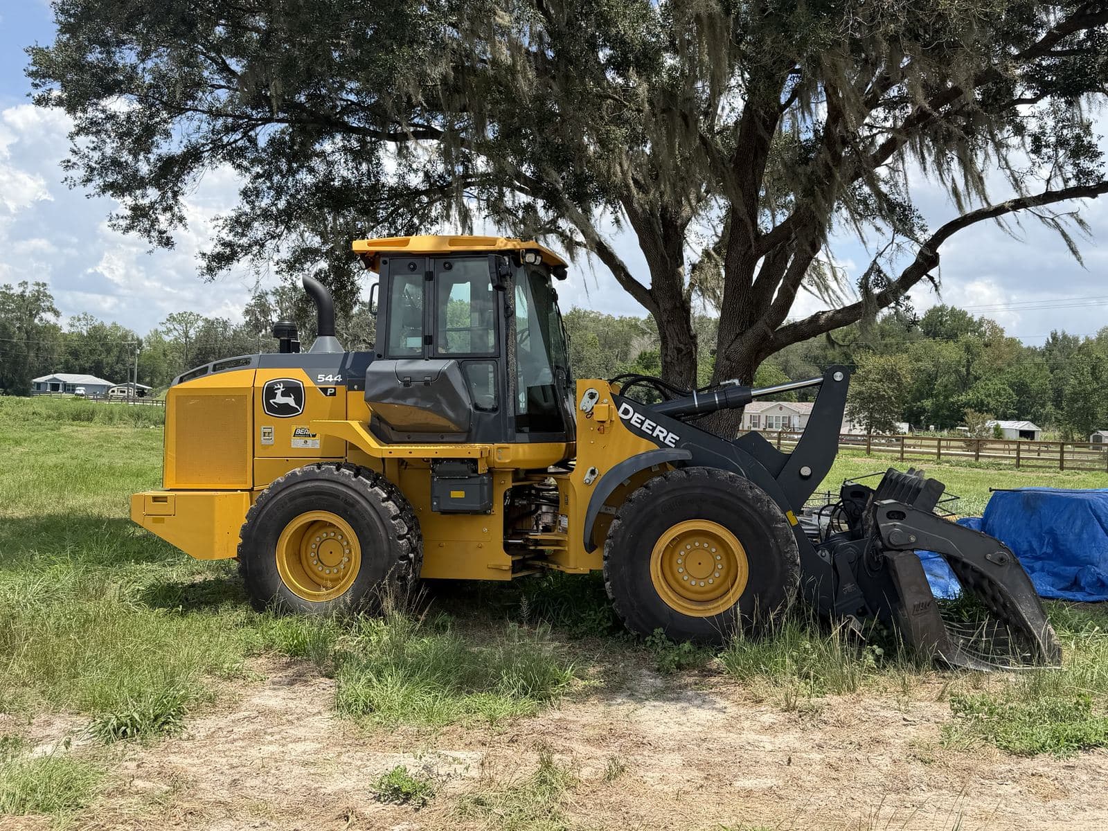 A-1 Land Management's John Deere 544 wheel loader with a grapple attachment